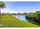 Scenic backyard pond view with manicured lawn and beautiful homes in a residential community at 379 Mikita Dr., Surfside Beach, SC 29575
