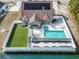 An aerial view shows the backyard oasis with a swimming pool, hot tub, and serene lake access at 400 Dog Pen Ct., Myrtle Beach, SC 29588