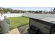 Private backyard with lush artificial turf, a hot tub, and a fenced in border with scenic pond views at 400 Dog Pen Ct., Myrtle Beach, SC 29588