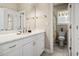 Clean bathroom featuring a vanity with white cabinets, a large mirror, and a separate toilet room at 400 Dog Pen Ct., Myrtle Beach, SC 29588
