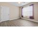 Bright, empty bedroom with wood-look floors and ample natural light from a large window at 400 Dog Pen Ct., Myrtle Beach, SC 29588