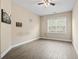 Bright bedroom with wood-look floors, ceiling fan, and a large window at 400 Dog Pen Ct., Myrtle Beach, SC 29588