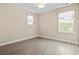 Bright bedroom featuring wood-look floors, neutral walls and two sunlit windows at 400 Dog Pen Ct., Myrtle Beach, SC 29588