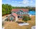 Beautiful two-story home featuring a brick and siding exterior, well-manicured lawn, and a serene lake view at 400 Dog Pen Ct., Myrtle Beach, SC 29588