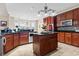 A spacious kitchen featuring an island, dark cabinetry, and granite countertops at 400 Dog Pen Ct., Myrtle Beach, SC 29588