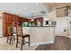 Eat-in kitchen with wood cabinets, black counters, breakfast bar, and stainless-steel appliances with tile flooring at 400 Dog Pen Ct., Myrtle Beach, SC 29588