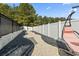 Landscaped side yard featuring a winding gravel path, bordered by a modern fence and mature trees at 400 Dog Pen Ct., Myrtle Beach, SC 29588