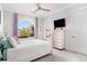 Serene bedroom with light purple curtains, a ceiling fan, and views of tropical trees at 400 Summerwood Ct., Myrtle Beach, SC 29579