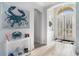Inviting foyer with arched doorways, a decorative painting, and ample natural light shining through the glass front door at 400 Summerwood Ct., Myrtle Beach, SC 29579