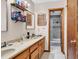 Bathroom featuring a double sink vanity, tiled floors, and a door to the shower at 405 Flagstone Dr., Myrtle Beach, SC 29588