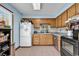 Cozy kitchen with wood cabinets, tiled floor, and white refrigerator at 405 Flagstone Dr., Myrtle Beach, SC 29588