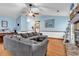 Spacious living room with vaulted ceilings, hardwood floors, and a cozy sectional sofa at 405 Flagstone Dr., Myrtle Beach, SC 29588