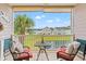 Relaxing balcony with seating and picturesque views of the community pond at 4142 Hibiscus Dr. # 20-202, Little River, SC 29566