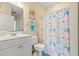 Clean bathroom featuring a vanity, toilet, shower/tub with curtain, and starfish decor at 4142 Hibiscus Dr. # 20-202, Little River, SC 29566
