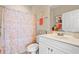 Well-lit bathroom with a vanity, toilet, shower/tub with curtain, and neutral color palette at 4142 Hibiscus Dr. # 20-202, Little River, SC 29566