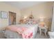 Cozy bedroom featuring a bed with a white comforter, a starfish, and access to a bathroom at 4142 Hibiscus Dr. # 20-202, Little River, SC 29566