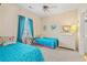 Comfortable bedroom with two beds, dresser, and window with bright turquoise decor at 4142 Hibiscus Dr. # 20-202, Little River, SC 29566