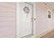 View of the unit's front door, a wreath, and the unit number at 4142 Hibiscus Dr. # 20-202, Little River, SC 29566
