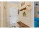 Inviting condo entryway featuring a decorative hat rack, a wooden bench, and tiled floors at 4142 Hibiscus Dr. # 20-202, Little River, SC 29566