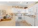 Bright kitchen featuring white appliances and cabinets, neutral countertops and plenty of natural light at 4142 Hibiscus Dr. # 20-202, Little River, SC 29566