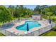 Relaxing community pool with lounge chairs and tables, surrounded by trees at 4142 Hibiscus Dr. # 20-202, Little River, SC 29566