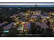 Evening aerial showcases a luxurious community, highlighting lighted pools, landscaping, and architecture at 434 Posada Dr., Myrtle Beach, SC 29572