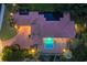 Stunning aerial view of a luxury home showcasing a sparkling pool and meticulous landscaping at twilight at 434 Posada Dr., Myrtle Beach, SC 29572