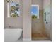 Bathroom featuring an open shower and a bathtub with views of the outside at 434 Posada Dr., Myrtle Beach, SC 29572