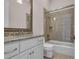 Bathroom featuring granite countertop, white cabinets, and tiled shower with glass doors at 434 Posada Dr., Myrtle Beach, SC 29572