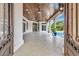 Beautiful tiled patio with a wood ceiling, ceiling fan, recessed lighting, arched openings, and access to the pool at 434 Posada Dr., Myrtle Beach, SC 29572