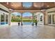 Gorgeous covered patio with tiled floors, three archways overlooking the pool, and a wood plank ceiling at 434 Posada Dr., Myrtle Beach, SC 29572