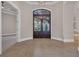 Elegant foyer featuring a dark wood door with glass panels and a high ceiling with modern lighting at 434 Posada Dr., Myrtle Beach, SC 29572