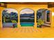 Picturesque backyard patio with archways and potted plants overlooking a pool, with a tranquil evening sky at 434 Posada Dr., Myrtle Beach, SC 29572