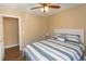 Bedroom featuring a ceiling fan, a queen bed with striped bedding, hardwood floors, and closet at 4370 Crepe Myrtle Ct. # F, Murrells Inlet, SC 29576