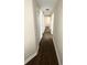 Hallway featuring wood floors, neutral walls, and multiple doorways at 4370 Crepe Myrtle Ct. # F, Murrells Inlet, SC 29576