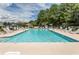 Inviting community pool with clear water, surrounded by ample seating and lush landscaping at 4370 Crepe Myrtle Ct. # F, Murrells Inlet, SC 29576