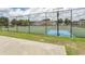 View of fenced tennis and basketball courts with manicured lawns and community buildings at 4370 Crepe Myrtle Ct. # F, Murrells Inlet, SC 29576