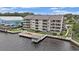 Aerial view showcases the building with a waterfront gazebo, deck, and serene water views at 4445 Kingsport Rd. # 101, Little River, SC 29566