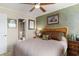 Comfortable bedroom featuring a rattan headboard, tropical-themed decor, and access to a well-appointed en-suite bathroom at 4445 Kingsport Rd. # 101, Little River, SC 29566