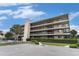 Multi-story condominium building with multiple balconies, landscaping, and a parking lot in front at 4445 Kingsport Rd. # 101, Little River, SC 29566