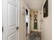 Condo hallway decorated with nautical-themed art and an open doorway to a bedroom, creating a coastal-inspired aesthetic at 4445 Kingsport Rd. # 101, Little River, SC 29566