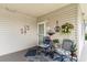 Inviting condo porch with comfortable seating, nautical decorations, and a welcoming entrance, ideal for relaxation at 4445 Kingsport Rd. # 101, Little River, SC 29566