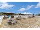 Spacious wooden deck featuring picnic tables and lounge seating with a waterfront view at 4445 Kingsport Rd. # 101, Little River, SC 29566