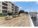 Inviting waterfront deck with lounge chairs and picnic tables overlooking the calm water at 4445 Kingsport Rd. # 101, Little River, SC 29566