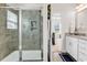 The bathroom features a sleek glass shower and double vanity, offering contemporary style and functionality at 447 Honeyhill Loop, Conway, SC 29526