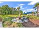 Outdoor picnic area with a firepit, seating, and a blue awning at 447 Honeyhill Loop, Conway, SC 29526