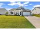 Charming single-story home with a well-manicured lawn and a two-car garage at 447 Honeyhill Loop, Conway, SC 29526