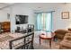 Cozy living area featuring a large TV, comfortable seating, and sliding glass doors at 4505 N Kings Hwy. # E2, Myrtle Beach, SC 29577
