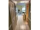 Inviting hallway with light-colored tile flooring, leading to a living area with natural light at 4753 Wild Iris Dr. # 301, Myrtle Beach, SC 29577