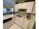 Bright kitchen features white cabinets, modern appliances, and a sink overlooking living area at 4753 Wild Iris Dr. # 301, Myrtle Beach, SC 29577
